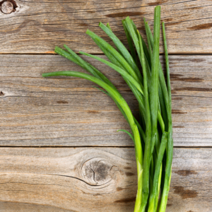 green onions on a wooden board